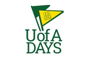 Decorative U of A Days banner has flags in university green and gold